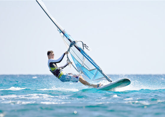 A água ostenta a placa inflável do SUP do PVC está acima da placa de pá Windsurf